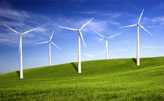 Photograph of three windmills in a green landscape.