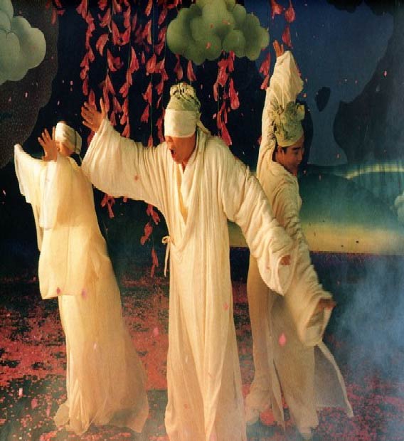Image from the movie Peach Blossom Land, with three men in white garb in a misty landscape.