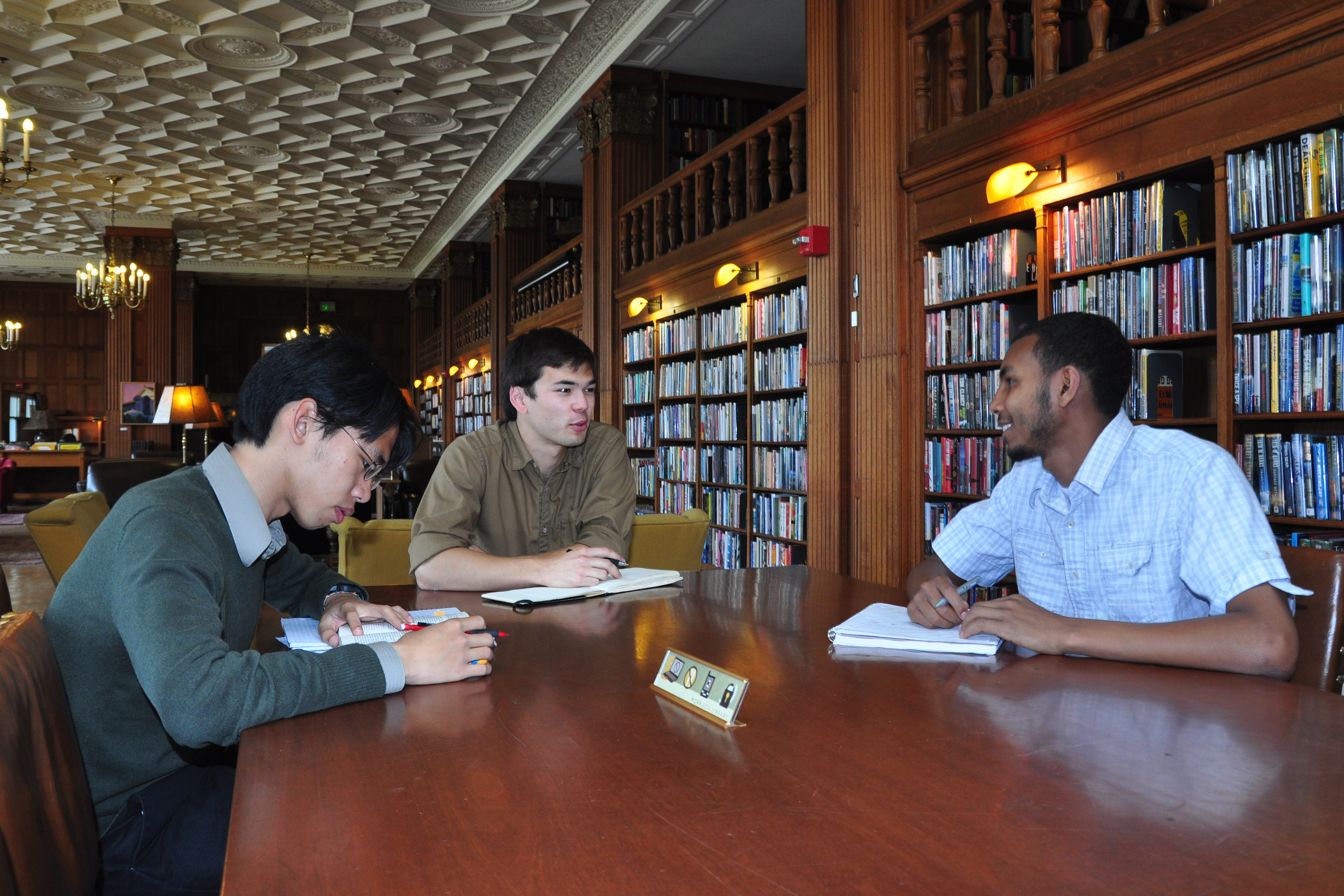 A group of students study together at the library.