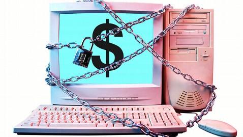 Image of a computer in chains and a lock. The computer screen shows a large dollar sign.