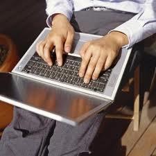 Photo of a man typing at a computer.