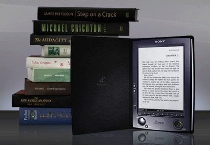 Photo of the Sony e-Reader next to a pile of books.