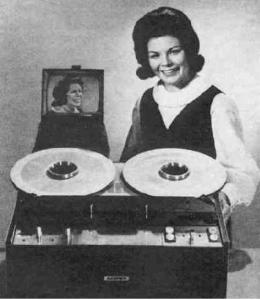 Old photo of a girl smiling over her new, now quite old, sound recording device.