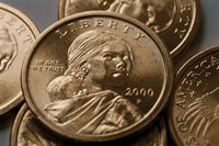 Photo of an American dollar coin featuring the face of a Native American woman.