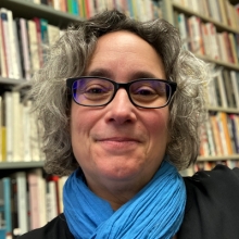 Estelle Tarica in front of Bookshelves