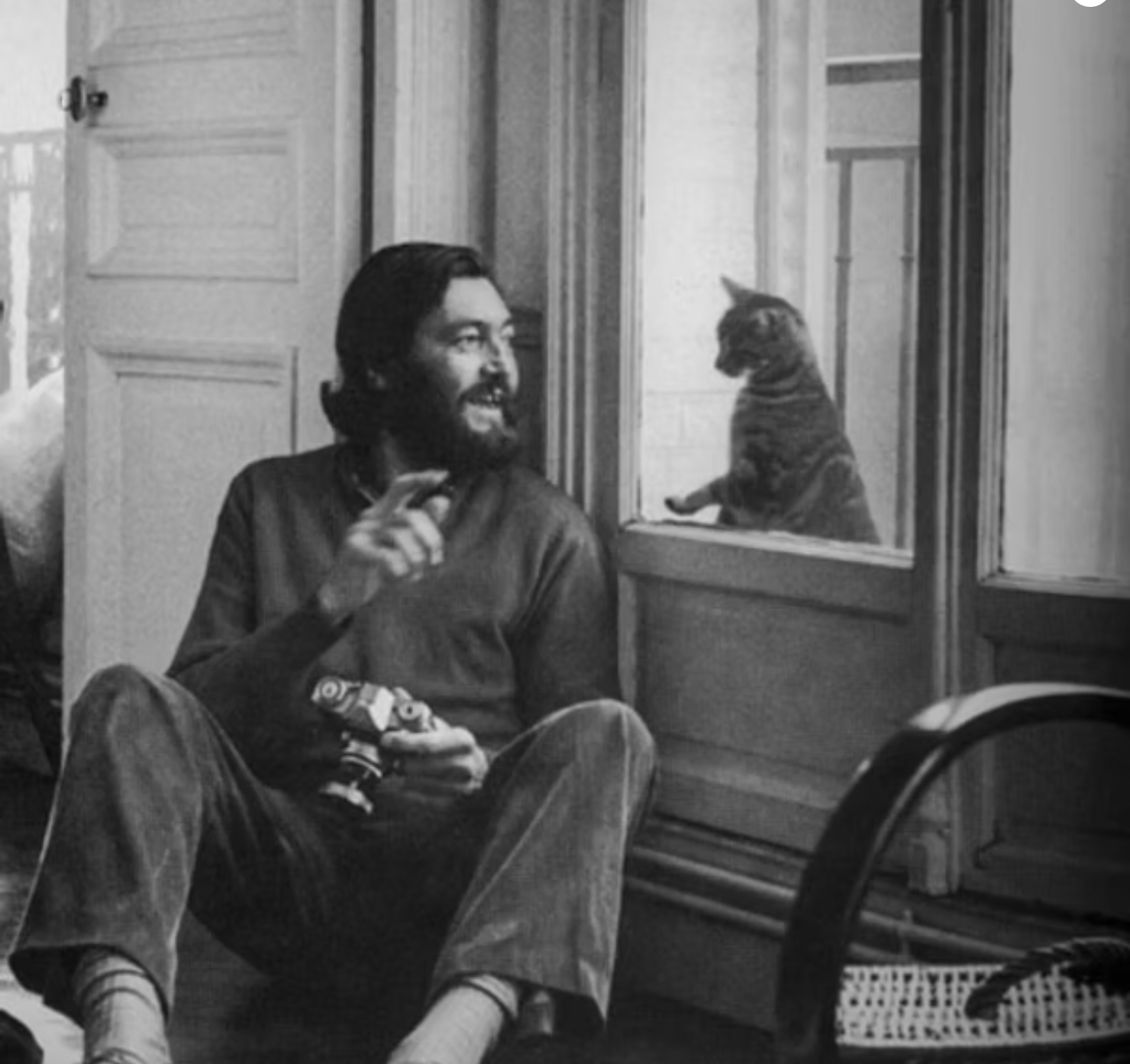 Man with Camera Speaking to a Cat in Window B&W Photo